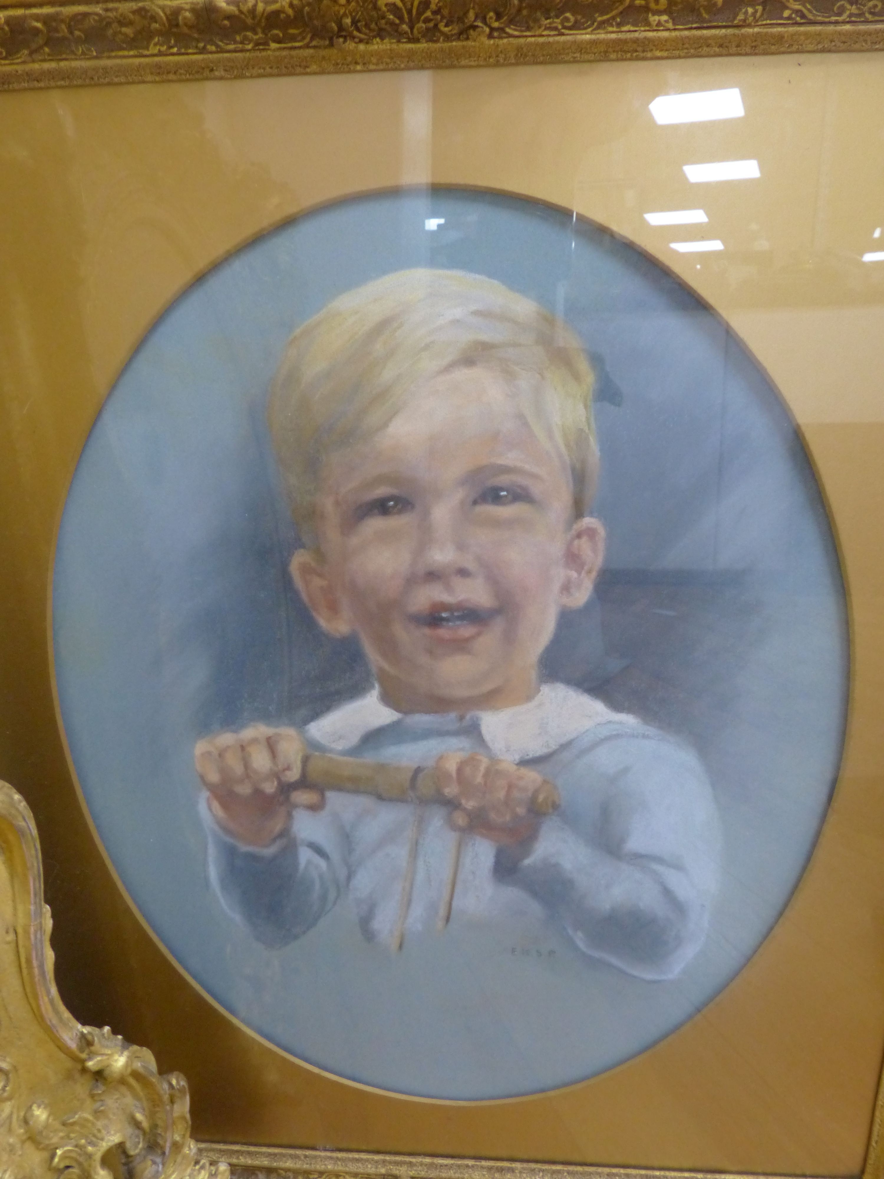 English School c.1900, overpainted print, Young woman with a dove, housed in a Victorian gilt gesso scroll frame, oval, 47 x 36cm, frame overall 76 x 66cm and a pastel portrait of a boy